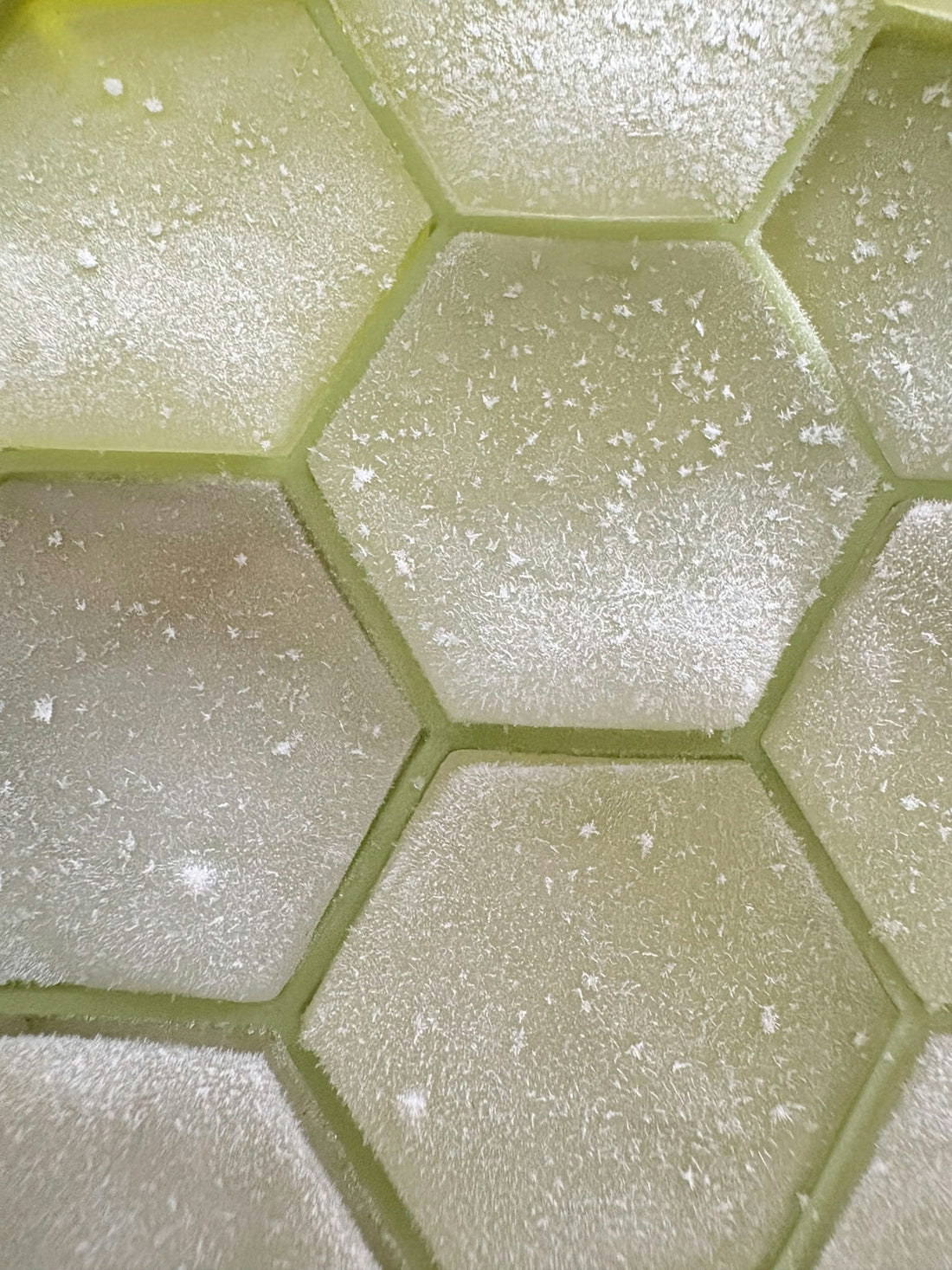 Close-up of frosted hexagonal shapes in a grid.